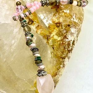 Lariat style long necklace of pink and taupe beads. 30 inches. End stone is pink